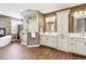 Spa-like bathroom featuring a glass enclosed shower, dual sinks, and soaking tub at 391 High Ridge Way, Castle Pines, CO 80108