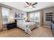 Comfortable bedroom featuring large windows, a ceiling fan, neutral paint, and stylish furnishings at 391 High Ridge Way, Castle Pines, CO 80108