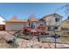 Backyard with a red-stained deck and a stone pathway at 1123 S Biscay St, Aurora, CO 80017