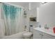 Clean bathroom features a shower and tub combo, along with a vanity sink and toilet at 1123 S Biscay St, Aurora, CO 80017