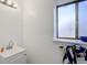 Small but efficient bathroom features a clean white vanity sink and a window for natural light at 1123 S Biscay St, Aurora, CO 80017