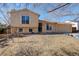 Split level home featuring an attached one car garage, lawn, and windows with white shutters at 1123 S Biscay St, Aurora, CO 80017