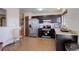 Kitchen with black cabinetry, stainless steel appliances, and a window at 1123 S Biscay St, Aurora, CO 80017