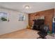 Living room with a red brick accent wall with a television on top at 1123 S Biscay St, Aurora, CO 80017