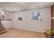 Cozy living room with brick fireplace and two windows at 1123 S Biscay St, Aurora, CO 80017