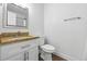 Neutral bathroom featuring granite countertop, white cabinets and new flooring at 1203 S Zeno Way # B, Aurora, CO 80017