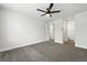 Bright bedroom featuring new carpet, a ceiling fan and access to an ensuite bath and walk-in closet at 1203 S Zeno Way # B, Aurora, CO 80017