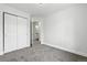 Bedroom with gray carpet, neutral walls and trim, closet with sliding doors, and ensuite bathroom at 1203 S Zeno Way # B, Aurora, CO 80017