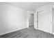 A bright bedroom features gray carpet, neutral walls and trim, and a closet with sliding doors at 1203 S Zeno Way # B, Aurora, CO 80017