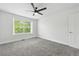 This bedroom features new carpet, a ceiling fan and a view to the neighborhood outside the window at 1203 S Zeno Way # B, Aurora, CO 80017