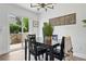 Dining area with a modern light fixture, a view of the backyard, and a stylish table setting at 1203 S Zeno Way # B, Aurora, CO 80017