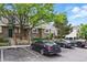 Well-maintained condo exterior with parking, sidewalks, manicured trees and landscaping at 1203 S Zeno Way # B, Aurora, CO 80017
