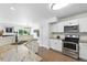 Well-lit kitchen featuring granite countertops, stainless steel appliances, and a view of the living area at 1203 S Zeno Way # B, Aurora, CO 80017