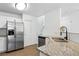 Modern kitchen with granite countertops, stainless steel appliances, and white cabinets at 1203 S Zeno Way # B, Aurora, CO 80017