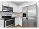 Modern kitchen featuring stainless steel appliances and white cabinets, offering a sleek design at 1203 S Zeno Way # B, Aurora, CO 80017