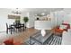 Open-concept living area with wood floors, modern lighting, and stylish decor at 1203 S Zeno Way # B, Aurora, CO 80017