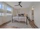 Bright bedroom with a queen bed, modern ceiling fan, and a view to the bathroom at 5189 Vivian St, Wheat Ridge, CO 80033