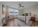 Bright bedroom with natural light, a brass bed frame, and a ceiling fan at 5189 Vivian St, Wheat Ridge, CO 80033