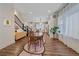 Inviting dining area with hardwood floors, a modern light fixture, and staircase at 5189 Vivian St, Wheat Ridge, CO 80033