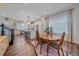 Open-concept dining area features a wooden table and chairs adjacent to the kitchen, bathed in natural light at 5189 Vivian St, Wheat Ridge, CO 80033