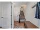 Inviting entryway with coat rack, a stylish bench, and easy access to the upper level via the staircase at 5189 Vivian St, Wheat Ridge, CO 80033