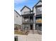 Stylish townhome features a covered porch, balcony, and modern exterior design with neutral color palette at 5189 Vivian St, Wheat Ridge, CO 80033