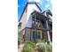 Modern townhome featuring brick accents and dark trim, plus balcony with seating area at 5189 Vivian St, Wheat Ridge, CO 80033