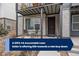 Inviting front porch with seating area, metal roof, and brick accents at 5189 Vivian St, Wheat Ridge, CO 80033