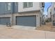 A gray two car garage with brick siding at 5189 Vivian St, Wheat Ridge, CO 80033