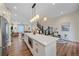 Open-concept kitchen with a large island, stainless steel appliances, and view of the dining and living areas at 5189 Vivian St, Wheat Ridge, CO 80033