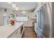 Bright kitchen featuring stainless appliances, white cabinets, and a center island with barstool seating at 5189 Vivian St, Wheat Ridge, CO 80033