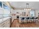 Bright, open kitchen featuring a large island with seating, stainless steel appliances, and modern lighting at 5189 Vivian St, Wheat Ridge, CO 80033