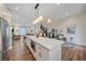 Open concept kitchen with stainless steel appliances and a large island, flowing into the dining and living areas at 5189 Vivian St, Wheat Ridge, CO 80033