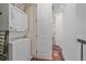 Laundry area with stacked washer and dryer with access to hallway at 5189 Vivian St, Wheat Ridge, CO 80033