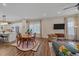 Open concept living room featuring hardwood floors, neutral decor, and kitchen access at 5189 Vivian St, Wheat Ridge, CO 80033