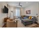 Contemporary living room featuring a large sectional sofa, stylish decor, and a ceiling fan for added comfort at 5189 Vivian St, Wheat Ridge, CO 80033