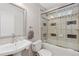 Cozy bathroom with a combined tub and shower, featuring decorative tiling and updated fixtures for a modern feel at 11970 W Pleasant Ave, Lakewood, CO 80401