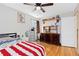 Bedroom with hardwood floors, a ceiling fan, and two dressers, perfect for storage and organization at 11970 W Pleasant Ave, Lakewood, CO 80401