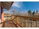 Wooden deck with railing, offering outdoor space for relaxing and enjoying the view of the yard at 11970 W Pleasant Ave, Lakewood, CO 80401