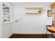 Bright dining area featuring dark wood floors and minimalist shelving, creating a blank canvas for personalized touches at 11970 W Pleasant Ave, Lakewood, CO 80401