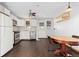 Eat-in kitchen featuring white cabinets, stainless steel appliances, and a wood table with chairs at 11970 W Pleasant Ave, Lakewood, CO 80401