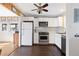 Galley kitchen featuring white cabinets, stainless steel appliances, and light countertops at 11970 W Pleasant Ave, Lakewood, CO 80401