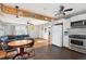 Cozy living room with a blend of modern and rustic elements, flowing into the open-concept kitchen with stainless steel appliances at 11970 W Pleasant Ave, Lakewood, CO 80401