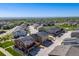 An aerial view showcasing a neighborhood with modern homes, solar panels, green spaces, and mountain views at 13711 Ash Cir, Thornton, CO 80602
