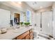 Well-lit bathroom features a spacious shower, large vanity, and walk-in closet at 13711 Ash Cir, Thornton, CO 80602