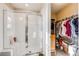 Bright bathroom with glass shower and access to a walk-in closet for storage at 13711 Ash Cir, Thornton, CO 80602