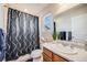 The bathroom includes a shower with decorative curtain and wood vanity at 13711 Ash Cir, Thornton, CO 80602