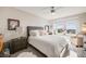 Bright bedroom with large window, plush bedding, and stylish bedside furniture at 13711 Ash Cir, Thornton, CO 80602
