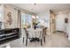 Cozy dining room with modern chandelier, table setting, and sliding glass doors at 13711 Ash Cir, Thornton, CO 80602
