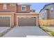Exterior of the home with two-car garage and driveway at 13711 Ash Cir, Thornton, CO 80602